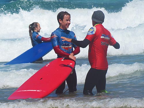 mike coaching a surf student in the sea