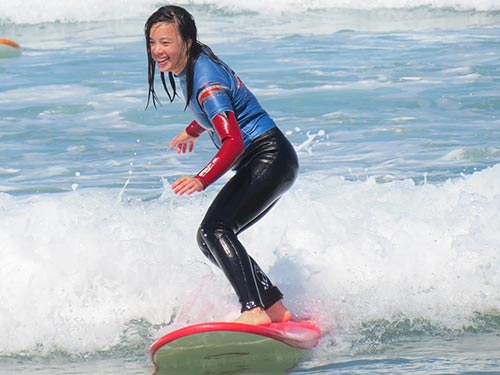 girl surfing and smiling 