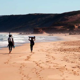 Picture of Mike and Taylor walking across Bordeira beach