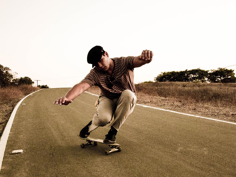 a man skateboarding down aroad